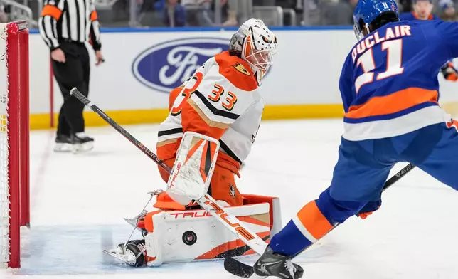 Anaheim Ducks goaltender Ville Husso (33) protect the net from New York Islanders left wing Anthony Duclair (11) during the second period of an NHL hockey game, Thursday, Dec. 11, 2025, in Elmont, N.Y. (AP Photo/Yuki Iwamura)