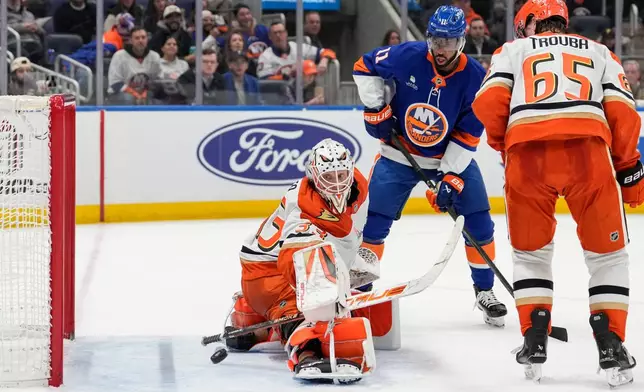 Anaheim Ducks goaltender Ville Husso (33) protests the net from New York Islanders left wing Anthony Duclair (11) during the second period of an NHL hockey game, Thursday, Dec. 11, 2025, in Elmont, N.Y. (AP Photo/Yuki Iwamura)