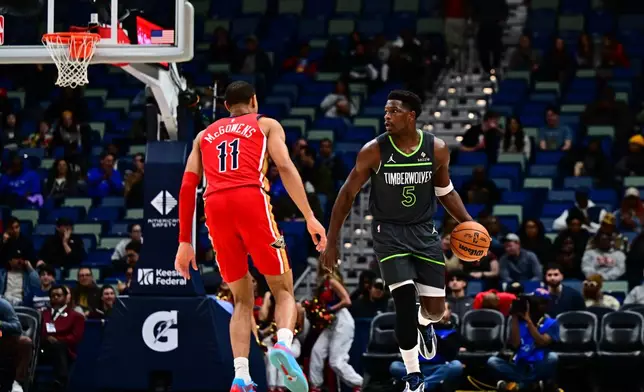 Minnesota Timberwolves guard Anthony Edwards (5) drives with the ball against New Orleans Pelicans guard Bryce McGowens (11) in the first half of an NBA basketball game in New Orleans, Thursday, Dec. 4, 2025. (AP Photo/Ella Hall)