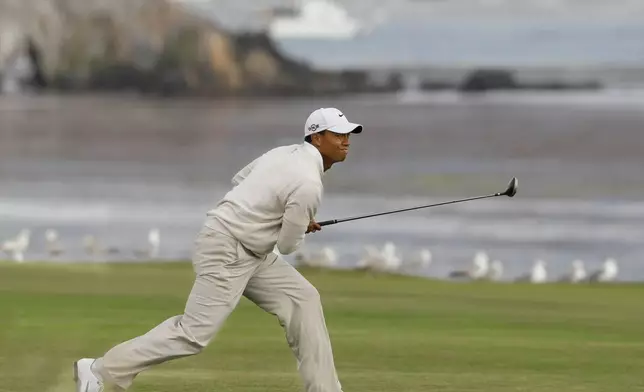 FILE - Tiger Woods watches his approach shot to the 18th green during the third round of the U.S. Open golf tournament Saturday, June 19, 2010, at the Pebble Beach Golf Links, in Pebble Beach, Calif. (AP Photo/Eric Risberg, File)