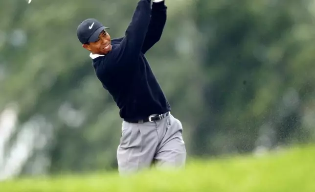 FILE - Tiger Woods hits his second shot on the 18th hole from a fairway bunker during completion of his second round of the PGA Championship at Hazeltine National Golf Club, in Chaska Minn., Saturday, Aug. 17, 2002. (AP Photo/Doug Mills)