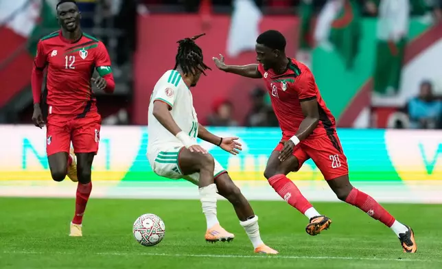 Sudan's Abo Eisa, right, challenges for the ball with Algeria's Hicham Boudaoui during the Africa Cup of Nations group E soccer match between Algeria and Sudan in Rabat, Morocco, Wednesday, Dec. 24, 2025. (AP Photo/Mosa'ab Elshamy)