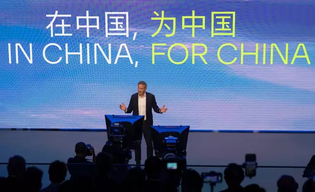 Olive Blume, Chairman of the Board of Management of Volkswagen Group, speaks near the slogan "In China, For China" during the Volkswagen Group media night ahead of the Auto Show in Shanghai, April 22, 2025. (AP Photo/Ng Han Guan)