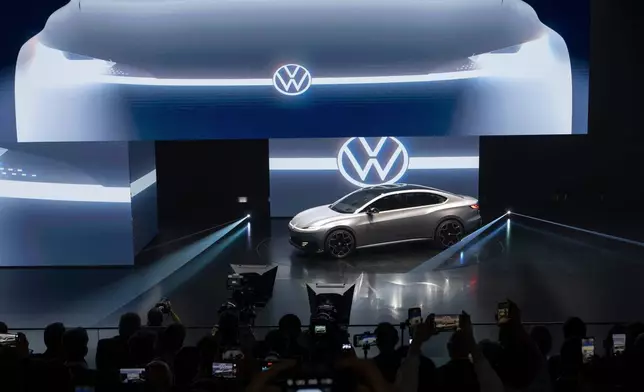 Attendees look at the ID.AURA concept car during the Volkswagen Group media night ahead of the Auto Show in Shanghai, April 22, 2025. (AP Photo/Ng Han Guan)
