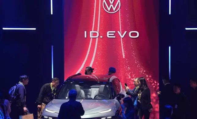 Attendees look at the ID.EVO concept car during the Volkswagen Group media night ahead of the Auto Show in Shanghai, April 22, 2025. (AP Photo/Ng Han Guan)