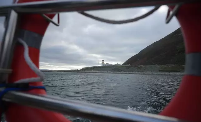 The lighthouse is seen from the small boat taking environmental officers to Ailsa Craig island, Scotland , Monday, Nov. 10, 2025. (AP Photo/Alastair Grant)