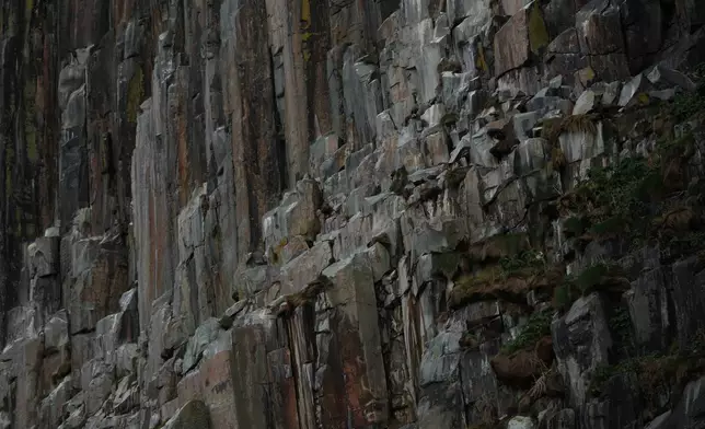The steep granite cliffs on Ailsa Craig island off the coast of Scotland, Monday, Nov. 10, 2025. (AP Photo/Alastair Grant)