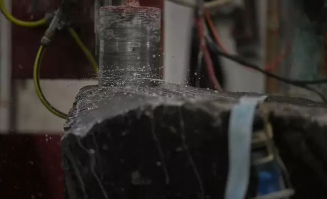 Blue Hone granite is machine cut from block of the rock at Kays Curling stone factory in Mauchline, Scotland, Tuesday, Nov. 11, 2025. (AP Photo/Alastair Grant)