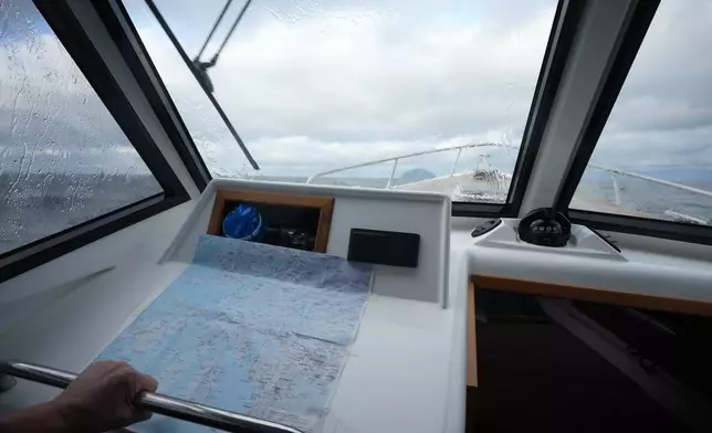A small boat carrying environmental officers heads towards the granite island of Ailsa Craig, Scotland, Monday, Nov. 10, 2025. (AP Photo/Alastair Grant)
