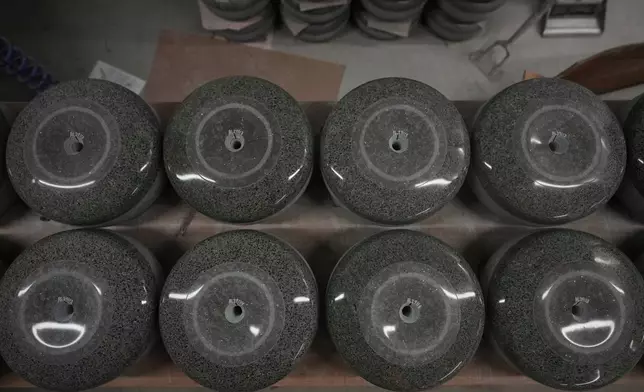 Curling stones await further machining during being manufacture at Kays Curling stone factory in Mauchline, Scotland, Tuesday, Nov. 11, 2025. (AP Photo/Alastair Grant)