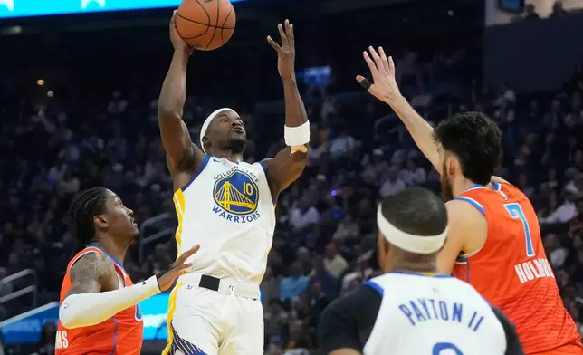 Golden State Warriors forward Jimmy Butler III (10) shoots against Oklahoma City Thunder guard Jalen Williams, left, and center Chet Holmgren (7) during the first half of an NBA basketball game in San Francisco, Tuesday, Dec. 2, 2025. (AP Photo/Jeff Chiu)