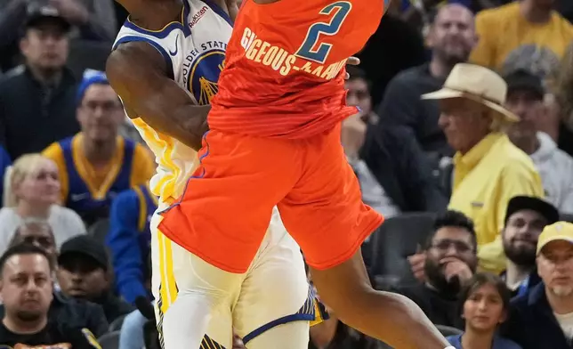 Oklahoma City Thunder guard Shai Gilgeous-Alexander (2) is fouled by Golden State Warriors forward Jimmy Butler III during the first half of an NBA basketball game in San Francisco, Tuesday, Dec. 2, 2025. (AP Photo/Jeff Chiu)