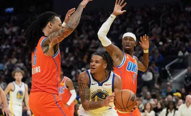 Golden State Warriors guard Will Richard (3) looks to pass the ball between Oklahoma City Thunder forward Jaylin Williams, left, and guard Shai Gilgeous-Alexander during the first half of an NBA basketball game in San Francisco, Tuesday, Dec. 2, 2025. (AP Photo/Jeff Chiu)