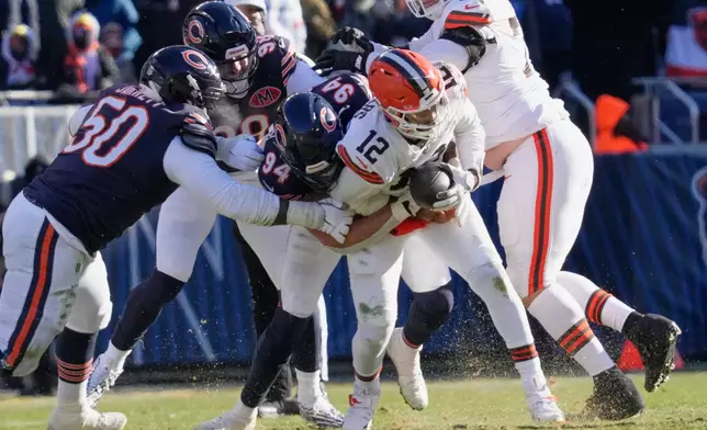 Chicago Bears defensive end Austin Booker (94) sacks Cleveland Browns quarterback Shedeur Sanders (12) in the first half of an NFL football game in Chicago, Sunday, Dec. 14, 2025. (AP Photo/Nam Y. Huh)