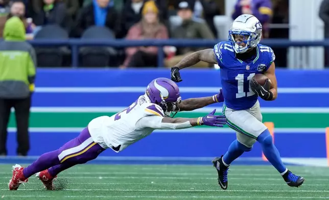 Seattle Seahawks wide receiver Jaxon Smith-Njigba (11) runs against Minnesota Vikings cornerback Isaiah Rodgers (2) during the second half of an NFL football game Sunday, Nov. 30, 2025, in Seattle. (AP Photo/Stephen Brashear)