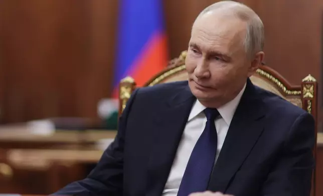 Russian President Vladimir Putin listens to Governor of the Kursk Region Alexander Khinshtein during their meeting at the Kremlin in Moscow, Monday, Dec. 1, 2025. (Gavriil Grigorov/Sputnik, Kremlin Pool Photo via AP)