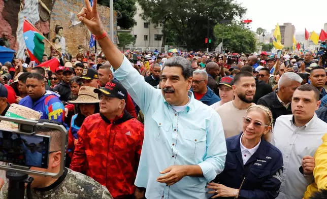 President Nicolas Maduro joins a rally marking the anniversary of the Battle of Santa Ines, which took place during Venezuela's 19th-century Federal War, in Caracas, Venezuela, Wednesday, Dec. 10, 2025. (AP Photo/Cristian Hernandez)