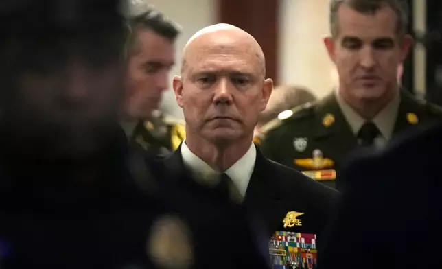 U.S. Navy Adm. Frank M. Bradley walks along a hallway after a meeting with senators on Capitol Hill, Thursday, Dec. 4, 2025, in Washington. (AP Photo/Mark Schiefelbein)