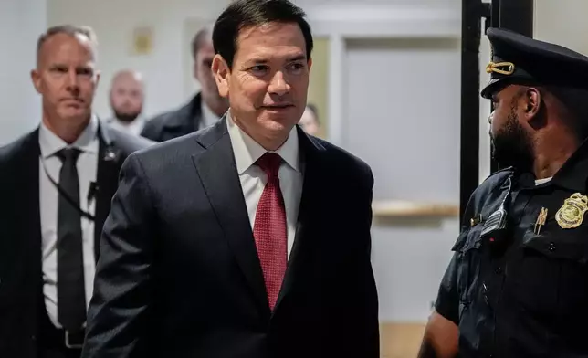 Secretary of State Marco Rubio walks to a secure room in the basement of the Capitol to brief senators on military strikes near Venezuela, Tuesday, Dec. 16, 2025, in Washington. (AP Photo/Julia Demaree Nikhinson)
