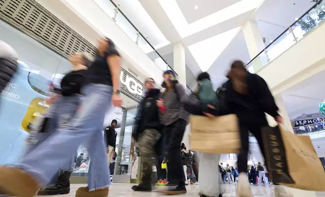 FILE - Shoppers browse through stores at Mall of America for Black Friday deals, Friday, Nov. 28, 2025, in Bloomington, Minn. (AP Photo/Adam Bettcher, File)
