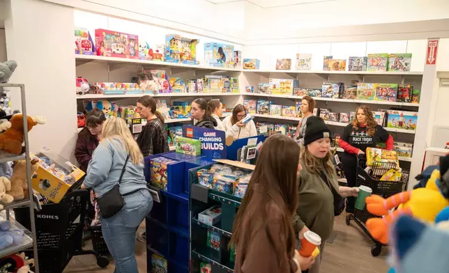 Shoppers browse through Kohl's department store for Black Friday deals, Friday, Nov. 28, 2025, in Woodstock, Ga. (AP Photo/Megan Varner)