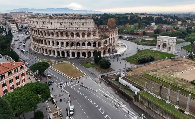 An aerial view of the Colosseum and the Arch of Titus, right, in Rome, Thursday, Dec. 4, 2025. (AP Photo/Andrew Medichini)