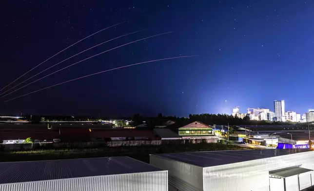 The Thai military fires artillery towards Cambodia, Friday, Dec. 26, 2025, seen from Thailand's Sa Kaeo province. (AP Photo/Wason Wanichakorn)