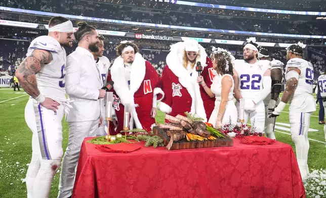 Minnesota Vikings cornerback Byron Murphy Jr. and linebacker Andrew van Ginkel are interviewed after the team's win against the Detroit Lions in an NFL football game, Thursday, Dec. 25, 2025, in Minneapolis. (AP Photo/Abbie Parr)