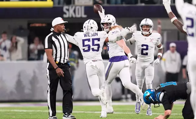 Minnesota Vikings linebacker Andrew van Ginkel, center, celebrates with linebacker Eric Wilson, left, and cornerback Isaiah Rodgers after recovering a fumble by Detroit Lions quarterback Jared Goff during the second half of an NFL football game, Thursday, Dec. 25, 2025, in Minneapolis. (AP Photo/Abbie Parr)