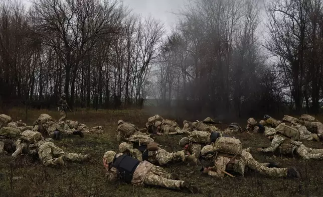 In this photo provided by Ukraine's 65th Mechanized Brigade press service, recruits attend drills at a training ground in the Zaporizhzhia region, Ukraine, Friday, Dec. 12, 2025. (Andriy Andriyenko/Ukraine's 65th Mechanized Brigade via AP)
