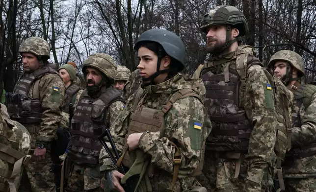 In this photo provided by Ukraine's 65th Mechanized Brigade press service, recruits attend drills at a training ground in the Zaporizhzhia region, Ukraine, Friday, Dec. 12, 2025. (Andriy Andriyenko/Ukraine's 65th Mechanized Brigade via AP)