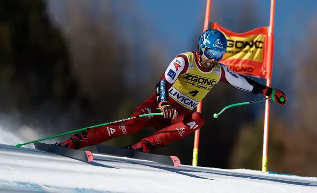 Austria's Marco Schwarz speeds down the course during an alpine ski, men's World Cup Super G, in Livigno, Italy, Saturday, Dec. 27, 2025. (AP Photo/Gabriele Facciotti)