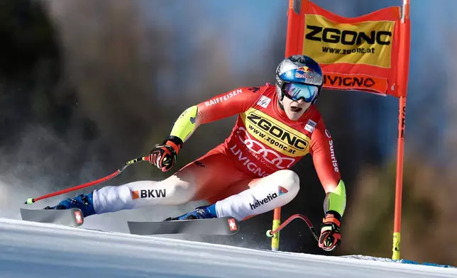 Switzerland's Marco Odermatt speeds down the course during an alpine ski, men's World Cup Super G, in Livigno, Italy, Saturday, Dec. 27, 2025. (AP Photo/Gabriele Facciotti)