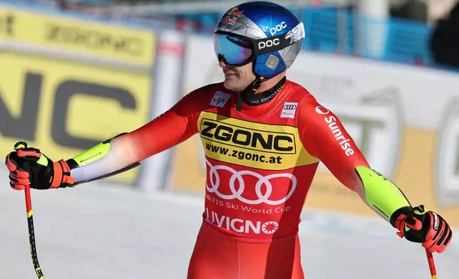 Switzerland's Marco Odermatt checks his time at the finish area of an alpine ski, men's World Cup Super G, in Livigno, Italy, Saturday, Dec. 27, 2025. (AP Photo/Marco Trovati)