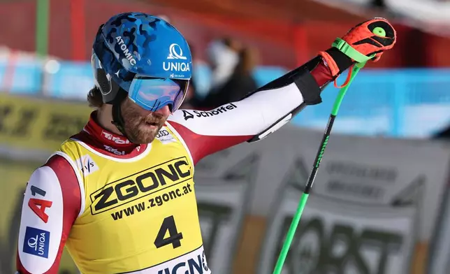 Austria's Marco Schwarz celebrates at the finish area of an alpine ski, men's World Cup Super G, in Livigno, Italy, Saturday, Dec. 27, 2025. (AP Photo/Marco Trovati)