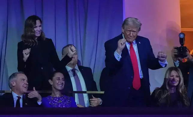 President Donald Trump dances toThe Village People as Canadian Prime Minister Mark Carney, Mexican President Claudia Sheinbaum and First Lady Melania smile during the draw for the 2026 soccer World Cup at the Kennedy Center in Washington, Friday, Dec. 5, 2025. (AP Photo/Jacquelyn Martin)