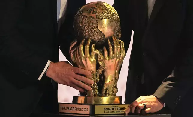 The FIFA Peace Prize is placed on a pedestal before being awarded to President Donald Trump during the draw for the 2026 soccer World Cup at the Kennedy Center in Washington, Friday, Dec. 5, 2025. (AP Photo/Stephanie Scarbrough, Pool)
