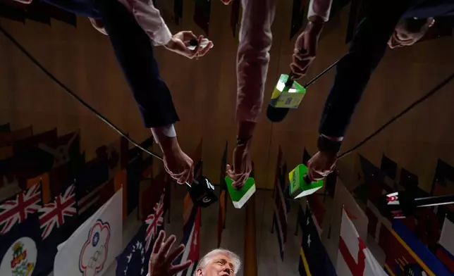 President Donald Trump speaks to reporters as he arrives to attend the draw for the 2026 soccer World Cup at the Kennedy Center in Washington, Friday, Dec. 5, 2025. (AP Photo/Julia Demaree Nikhinson)