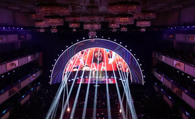 Singer Robbie Williams and singer and actor Nicole Scherzinger perform during the draw for the 2026 soccer World Cup at the Kennedy Center in Washington, Friday, Dec. 5, 2025. (AP Photo/Alex Brandon)