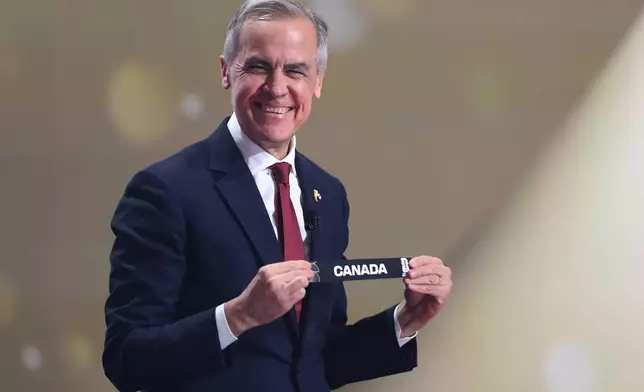 Canadian Prime Minister Mark Carney smiles during the draw for the 2026 soccer World Cup at the Kennedy Center in Washington, Friday, Dec. 5, 2025. (Dan Mullan/Pool Photo via AP)