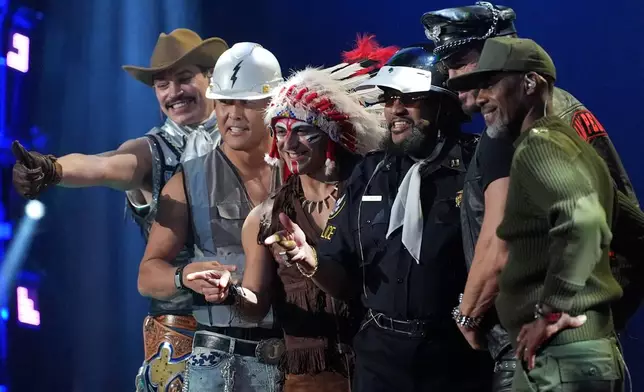 The Village People pose for a photo after performing at the draw for the 2026 soccer World Cup at the Kennedy Center in Washington, Friday, Dec. 5, 2025. (AP Photo/Jacquelyn Martin)