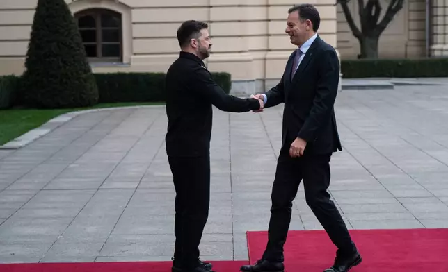 Ukraine's President Volodymyr Zelenskyy, left, shakes hands with Portuguese Prime Minister Luís Montenegro in Kyiv, Ukraine, Saturday, Dec. 20, 2025. (AP Photo/Danylo Antoniuk)