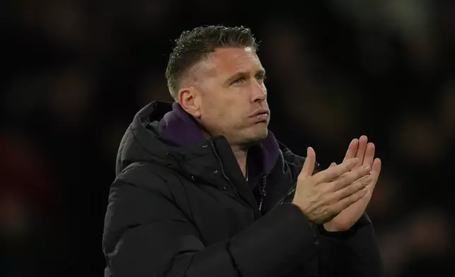 Wolverhampton Wanderers' head coach Rob Edwards walks off the pith after the Premier League soccer match between Wolverhampton Wandere and Manchester United in Wolverhampton, England Monday, Dec. 8, 2025. (AP Photo/Dave Shopland)