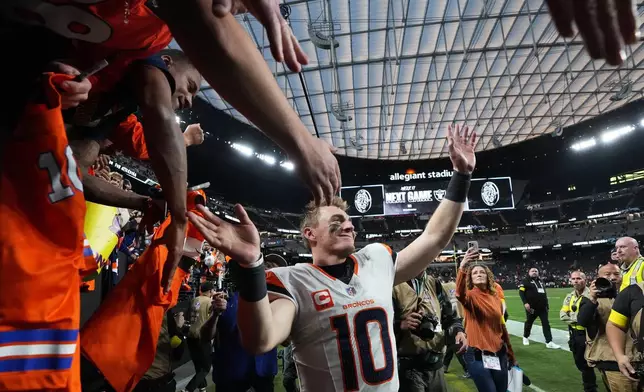 Denver Broncos quarterback Bo Nix (10) celebrates with fans after an NFL football game against the Las Vegas Raiders in Las Vegas, Sunday, Dec. 7, 2025. (AP Photo/Gregory Bull)