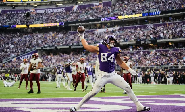 Minnesota Vikings tight end Josh Oliver (84) celebrates after scoring a touchdown during the second half of an NFL football game against the Washington Commanders, Sunday, Dec. 7, 2025, in Minneapolis. (AP Photo/Abbie Parr)