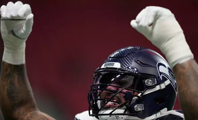 Seattle Seahawks defensive end Leonard Williams gestures during warmups before an NFL football game against the Atlanta Falcons, Sunday, Dec. 7, 2025, in Atlanta. (AP Photo/Brynn Anderson)