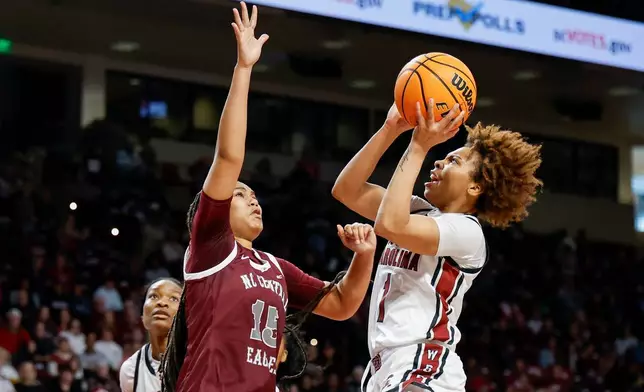 South Carolina guard Maddy McDaniel (1) drives to the basket against North Carolina Central forward Dianna Blake during the first half of an NCAA college basketball game in Columbia, S.C., Sunday, Dec. 7, 2025. (AP Photo/Nell Redmond)
