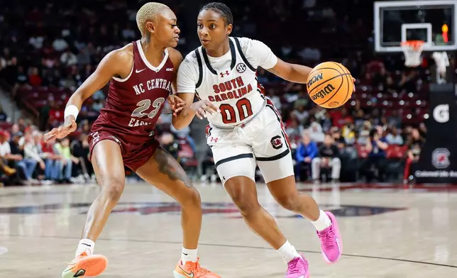 South Carolina guard Ta'Niya Latson (00) drives against North Carolina Central guard Najah Lane during the first half of an NCAA college basketball game in Columbia, S.C., Sunday, Dec. 7, 2025. (AP Photo/Nell Redmond)