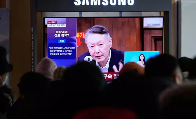 A TV screen shows a file image of South Korea's ousted President Yoon Suk Yeol during a news program at the Seoul Railway Station in Seoul, South Korea, Monday, Dec. 15, 2025. (AP Photo/Ahn Young-joon)