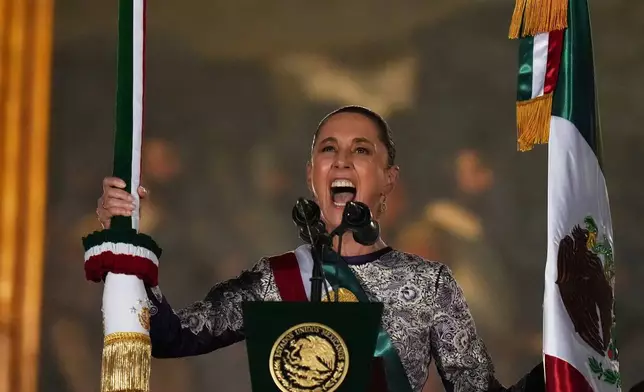 FILE - President Claudia Sheinbaum rings the bell as she gives the annual independence shout from the balcony of the National Palace to kick off Independence Day celebrations at the Zocalo, Mexico City's main square, Sept. 15, 2025. (AP Photo/Eduardo Verdugo, File)